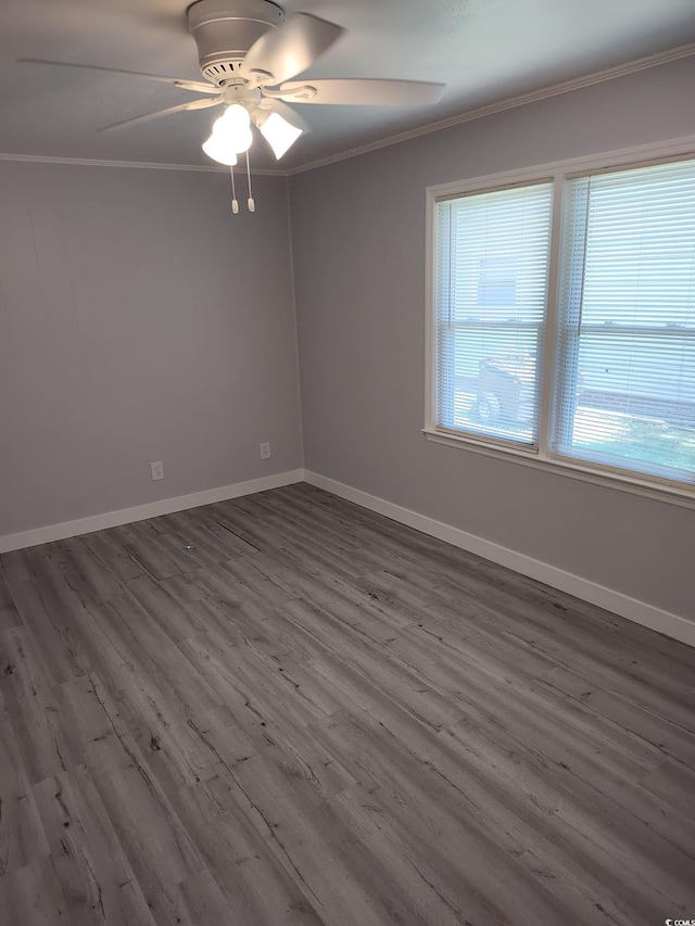 725 Juniper Dr, Surfside Beach, SC 29575 - spare room with ornamental molding, dark wood-style floors, ceiling fan, and baseboards