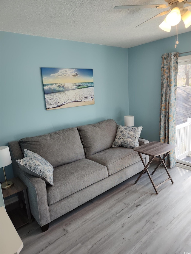 725 Juniper Dr, Surfside Beach, SC 29575 - living room featuring wood finished floors, a textured ceiling, and ceiling fan