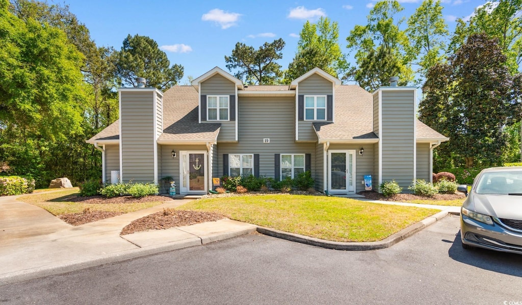 503 20th Ave N Unit 19-C, North Myrtle Beach, SC 29582 - townhome / multi-family property featuring a front yard, roof with shingles, and a chimney