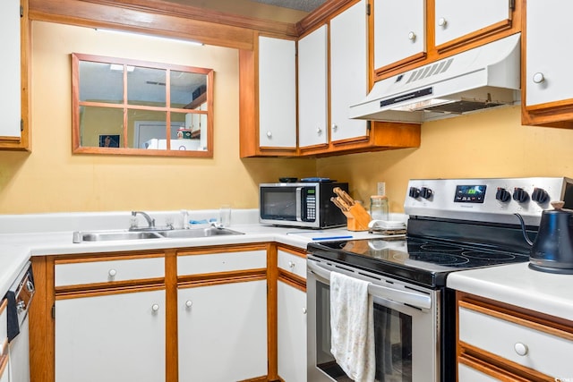 kitchen featuring under cabinet range hood, appliances with stainless steel finishes, a sink, light countertops, and white cabinets