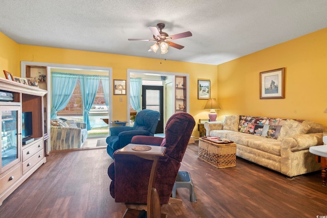 living area featuring a ceiling fan, wood finished floors, and a textured ceiling