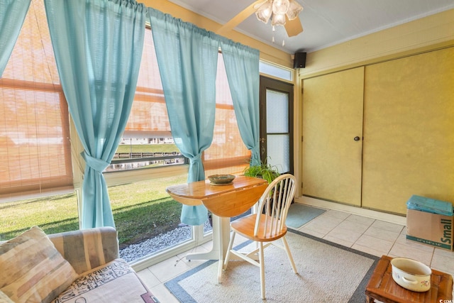 sunroom / solarium featuring tile patterned floors and ornamental molding