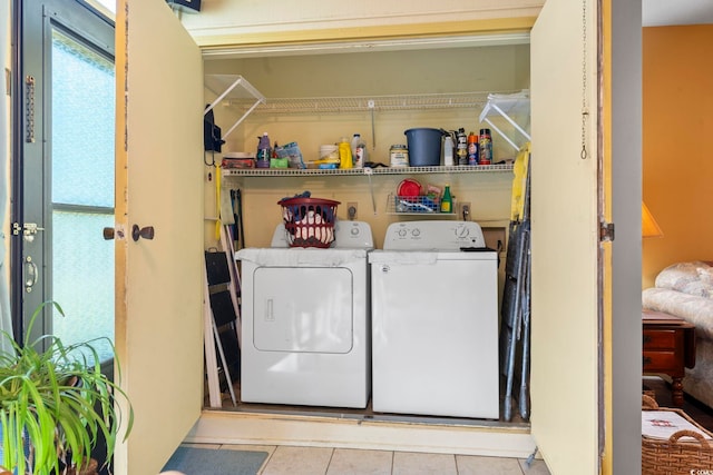 laundry room featuring separate washer and dryer and tile patterned floors