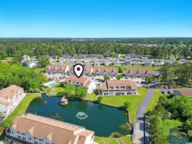 aerial view of property and surrounding area featuring a nearby body of water