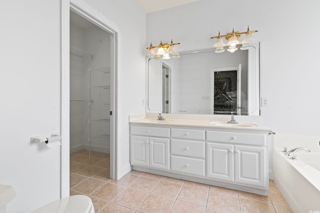 full bathroom featuring a bath, double vanity, tile patterned floors, and a sink