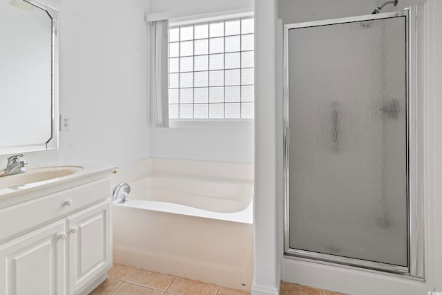 bathroom featuring a bath, tile patterned flooring, a stall shower, and plenty of natural light