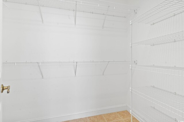 spacious closet with light tile patterned flooring