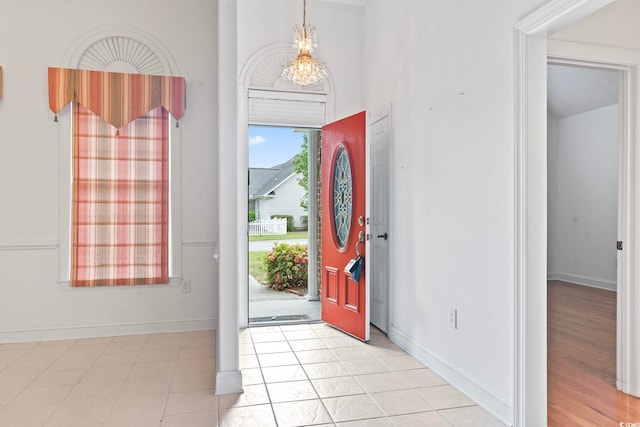 entrance foyer featuring baseboards and a notable chandelier
