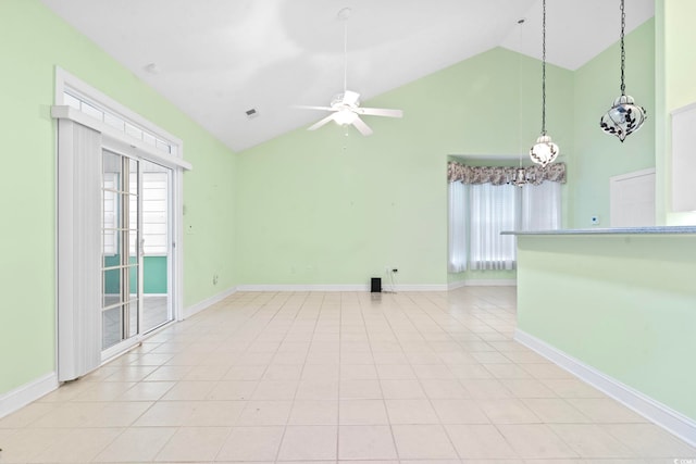 spare room with ceiling fan with notable chandelier, baseboards, high vaulted ceiling, and visible vents