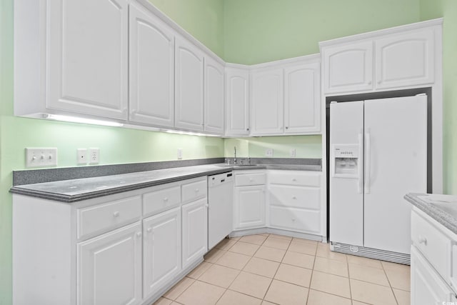 kitchen featuring white appliances, a sink, and white cabinetry
