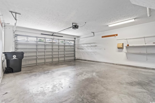 garage with baseboards and a garage door opener