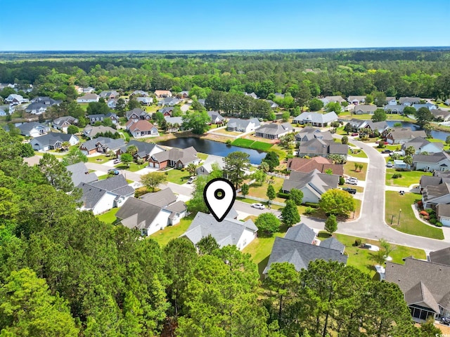 aerial view featuring a wooded view and a residential view