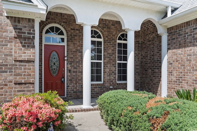 doorway to property with brick siding
