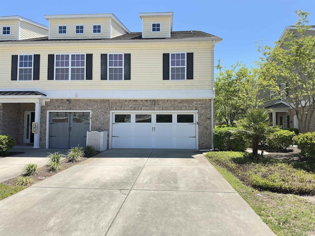 514 Hay Hill Ln Unit C, Myrtle Beach, SC 29579 - view of front facade with concrete driveway, an attached garage, and brick siding