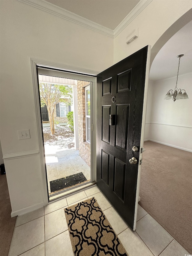 514 Hay Hill Ln Unit C, Myrtle Beach, SC 29579 - foyer entrance with arched walkways, a chandelier, crown molding, light tile patterned flooring, and light colored carpet