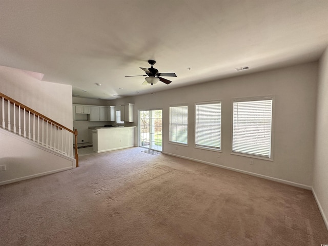 514 Hay Hill Ln Unit C, Myrtle Beach, SC 29579 - unfurnished living room featuring baseboards, light colored carpet, ceiling fan, and stairs