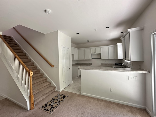 514 Hay Hill Ln Unit C, Myrtle Beach, SC 29579 - kitchen with a peninsula, a sink, light carpet, baseboards, and recessed lighting