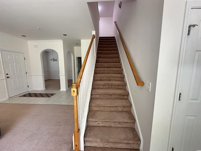 514 Hay Hill Ln Unit C, Myrtle Beach, SC 29579 - staircase featuring arched walkways, tile patterned floors, carpet flooring, baseboards, and crown molding