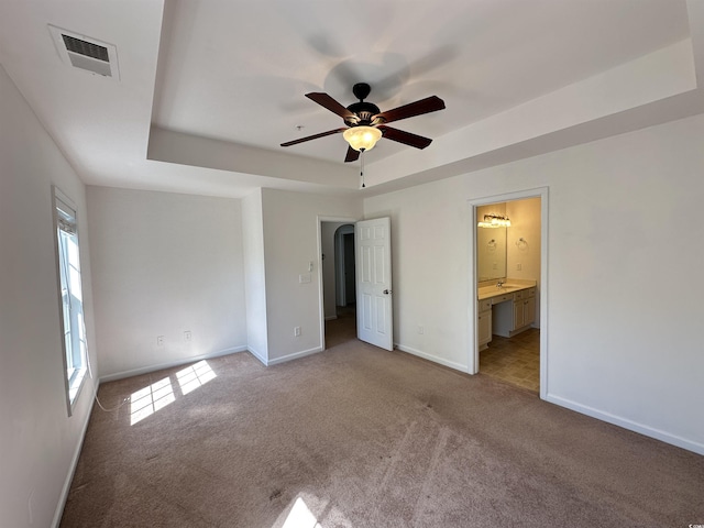 514 Hay Hill Ln Unit C, Myrtle Beach, SC 29579 - unfurnished bedroom featuring a raised ceiling, carpet flooring, baseboards, connected bathroom, and a ceiling fan