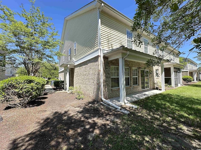 514 Hay Hill Ln Unit C, Myrtle Beach, SC 29579 - view of side of home with brick siding, a yard, and a patio area
