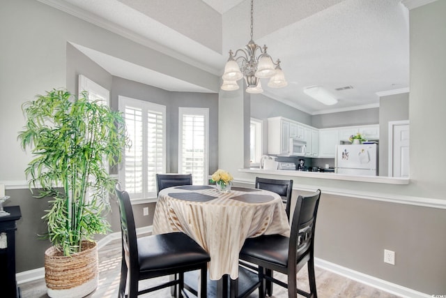 1533 Lanterns Rest Rd Unit 304, Myrtle Beach, SC 29579 - dining area featuring visible vents, light wood-type flooring, crown molding, baseboards, and a chandelier