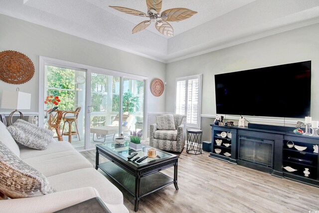 1533 Lanterns Rest Rd Unit 304, Myrtle Beach, SC 29579 - living area featuring plenty of natural light, light wood-style flooring, ornamental molding, and ceiling fan