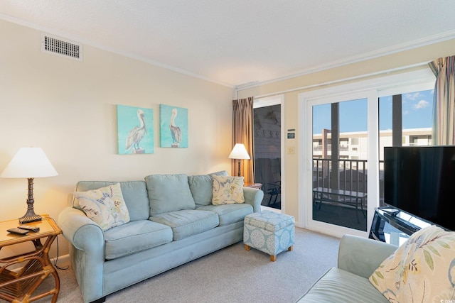 living room with carpet, visible vents, and crown molding