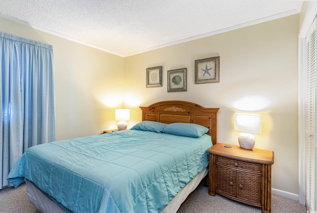 carpeted bedroom with a closet, a textured ceiling, baseboards, and ornamental molding