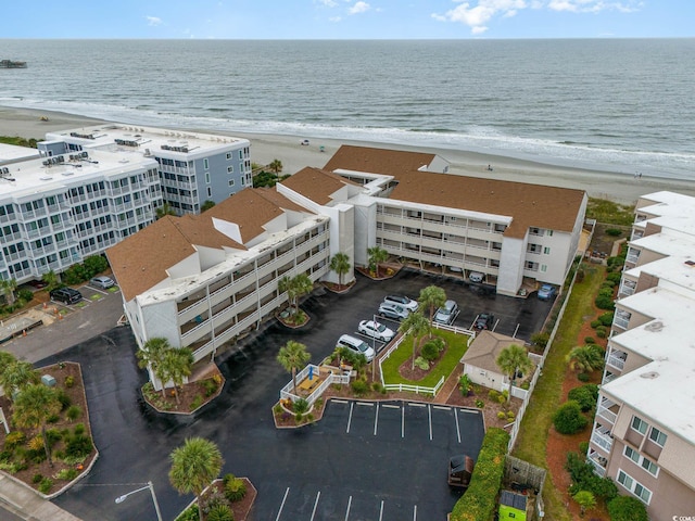 birds eye view of property featuring a view of the beach and a water view