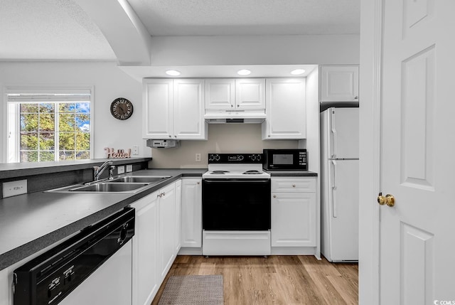 4430 Eastport Blvd Unit L15, Little River, SC 29566 - kitchen with white appliances, under cabinet range hood, light wood-style floors, white cabinetry, and dark countertops