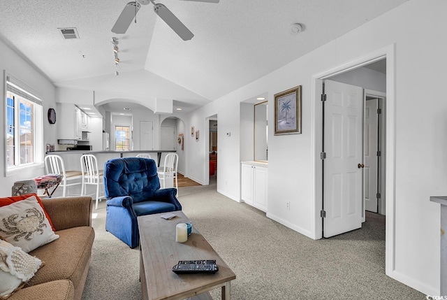 4430 Eastport Blvd Unit L15, Little River, SC 29566 - living area featuring arched walkways, a ceiling fan, lofted ceiling, light carpet, and a textured ceiling