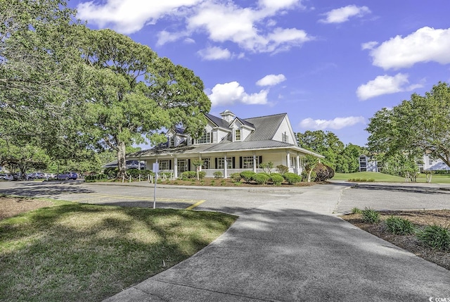 4430 Eastport Blvd Unit L15, Little River, SC 29566 - farmhouse-style home with a porch, a front yard, driveway, and a metal roof