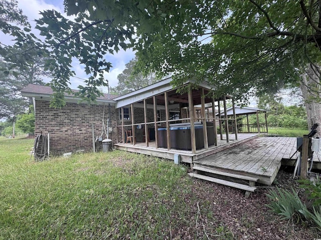 2560 Wise Rd, Conway, SC 29526 - rear view of property featuring brick siding, a hot tub, and a wooden deck