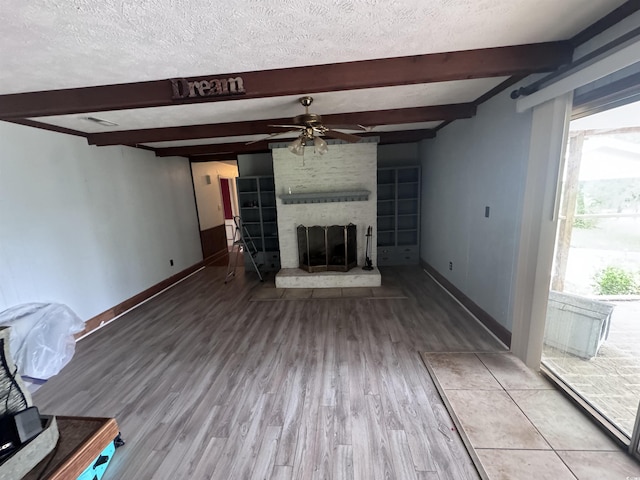 2560 Wise Rd, Conway, SC 29526 - unfurnished living room with a brick fireplace, a ceiling fan, and beam ceiling