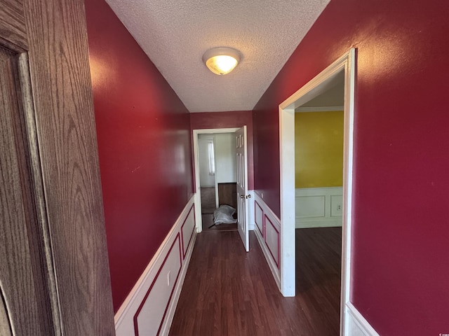 2560 Wise Rd, Conway, SC 29526 - corridor with dark wood-type flooring, a textured ceiling, and a wainscoted wall