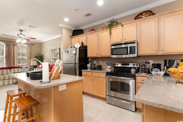 830 Howard Ave Unit D, Myrtle Beach, SC 29577 - kitchen featuring appliances with stainless steel finishes, light brown cabinets, a breakfast bar, crown molding, and ceiling fan
