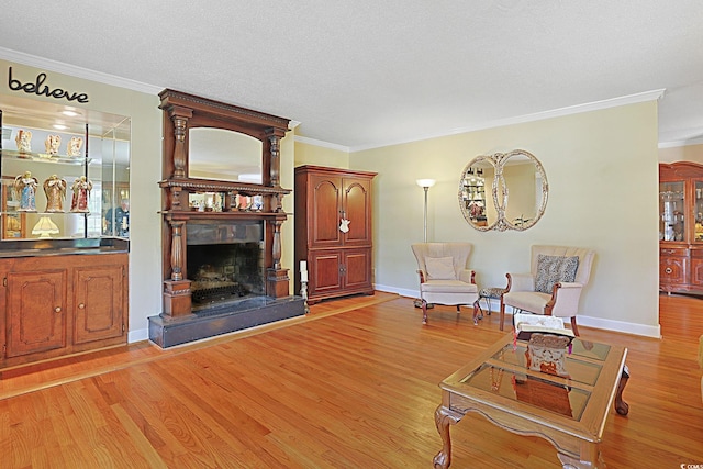 412 43rd Ave N, Myrtle Beach, SC 29577 - living area featuring light wood-style floors, ornamental molding, a fireplace with raised hearth, baseboards, and a textured ceiling