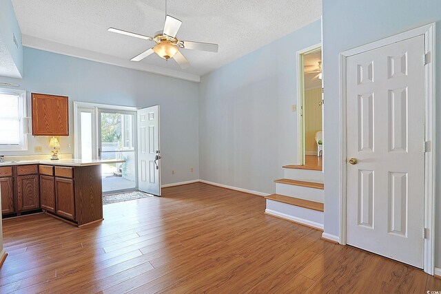 412 43rd Ave N, Myrtle Beach, SC 29577 - kitchen featuring ceiling fan, wood finished floors, a textured ceiling, light countertops, and a peninsula