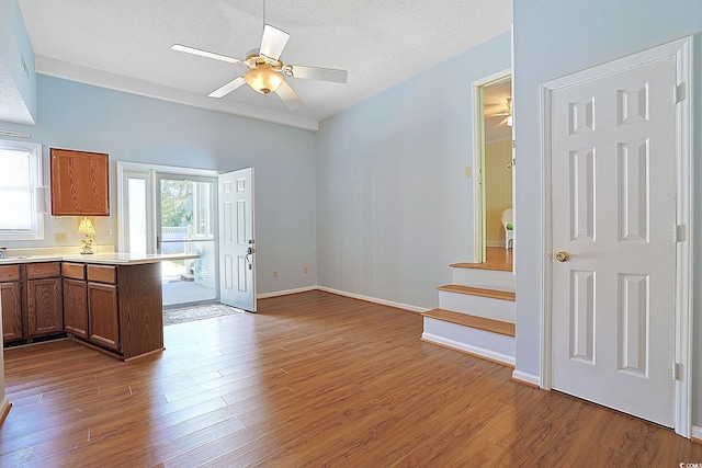412 43rd Ave N, Myrtle Beach, SC 29577 - kitchen featuring a ceiling fan, wood finished floors, a peninsula, light countertops, and a textured ceiling