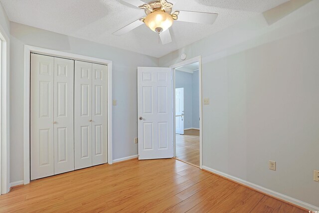 412 43rd Ave N, Myrtle Beach, SC 29577 - unfurnished bedroom featuring light wood-style floors, baseboards, a closet, and a ceiling fan