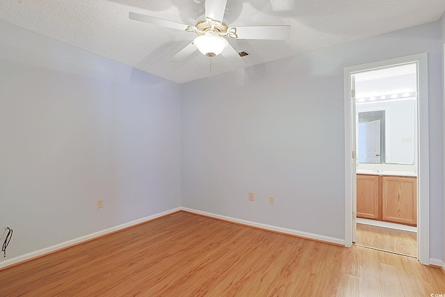 412 43rd Ave N, Myrtle Beach, SC 29577 - spare room featuring light wood-style floors, baseboards, a textured ceiling, and a ceiling fan