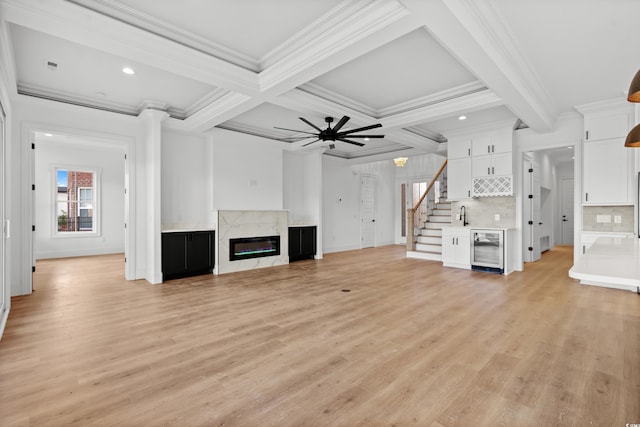 1219 Bentcreek Ln, Myrtle Beach, SC 29579 - unfurnished living room with wine cooler, light wood-style flooring, a premium fireplace, ornamental molding, and baseboards