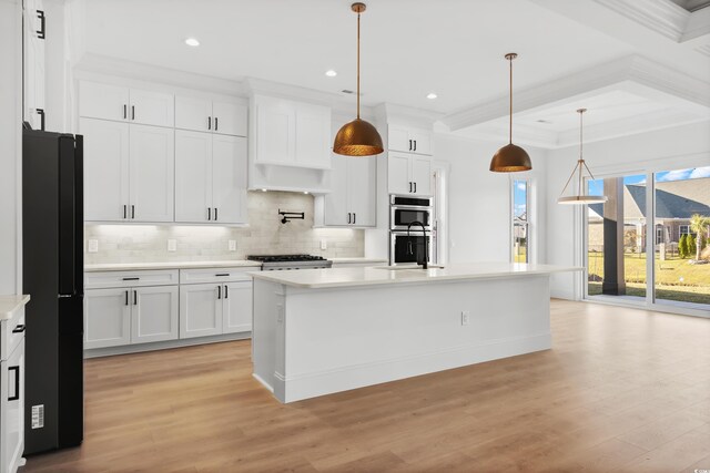 1219 Bentcreek Ln, Myrtle Beach, SC 29579 - kitchen featuring light countertops, crown molding, decorative backsplash, light wood-style floors, and white cabinetry