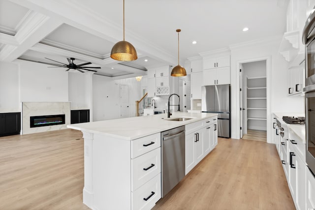 1219 Bentcreek Ln, Myrtle Beach, SC 29579 - kitchen featuring appliances with stainless steel finishes, a sink, light wood-style flooring, a ceiling fan, and white cabinetry