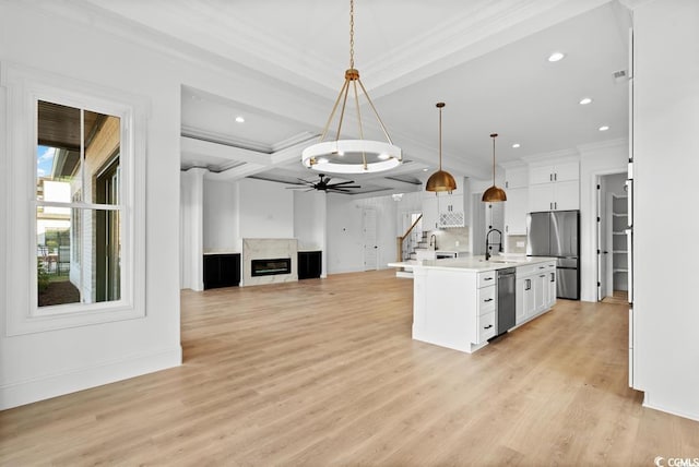 1219 Bentcreek Ln, Myrtle Beach, SC 29579 - kitchen with appliances with stainless steel finishes, crown molding, light countertops, white cabinetry, and ceiling fan