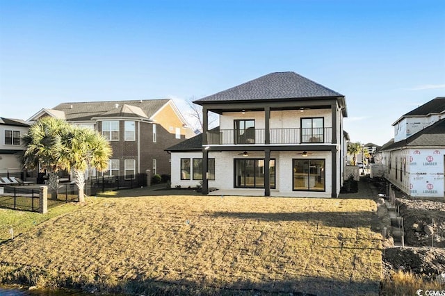 1219 Bentcreek Ln, Myrtle Beach, SC 29579 - back of property featuring a ceiling fan, a balcony, a fenced backyard, a shingled roof, and a patio area