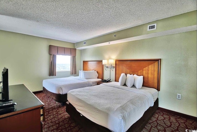 504 N Ocean Blvd Unit 1810, Myrtle Beach, SC 29577 - bedroom featuring baseboards, a textured ceiling, visible vents, and carpet