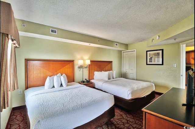 504 N Ocean Blvd Unit 1810, Myrtle Beach, SC 29577 - bedroom with a textured ceiling, visible vents, and a closet
