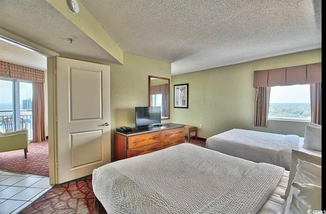 504 N Ocean Blvd Unit 1810, Myrtle Beach, SC 29577 - tiled bedroom featuring a textured ceiling and multiple windows