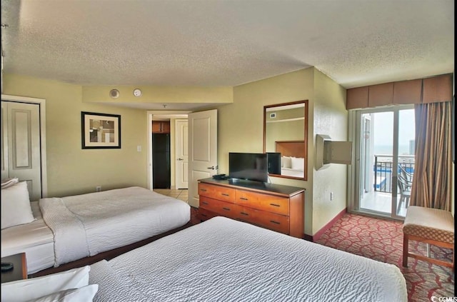 504 N Ocean Blvd Unit 1810, Myrtle Beach, SC 29577 - bedroom featuring a textured ceiling, baseboards, and access to exterior